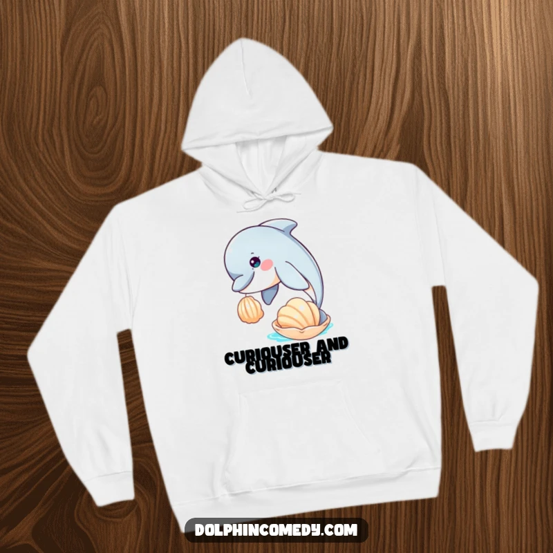 Funny hooded sweatshirt depicting a curious dolphin nudging a seashell, perfect for cozying up with a sense of wonder.