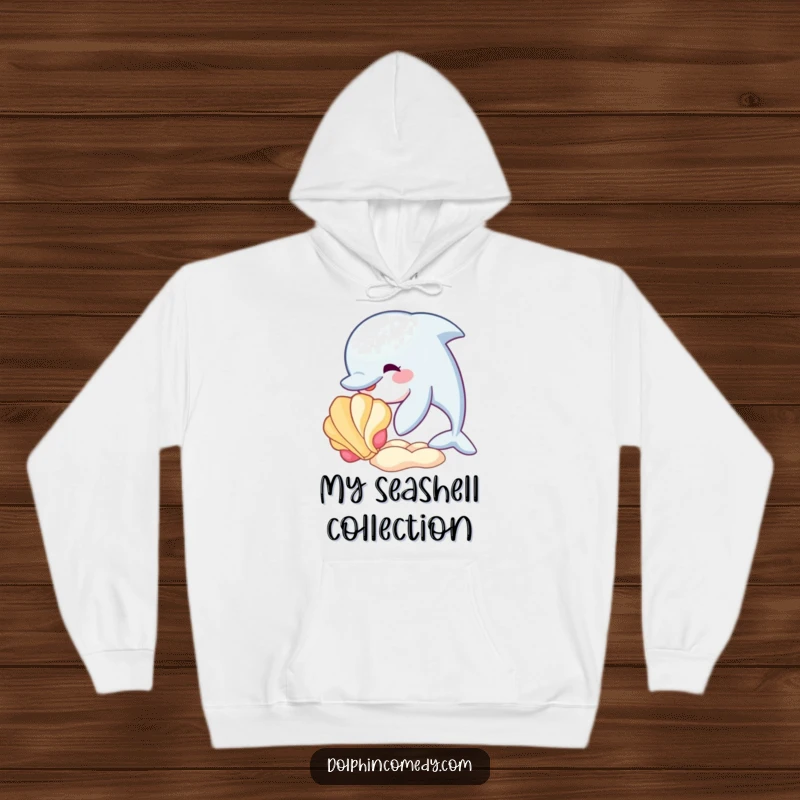 Funny hoodie featuring a dolphin playfully interacting with a colorful seashell, perfect for cozying up with ocean-themed humor.