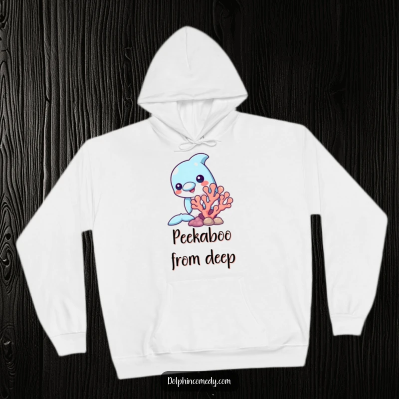Funny hoodie showcasing a dolphin curiously peeking from behind a coral reef, designed for warmth and underwater charm.