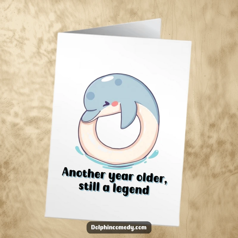 Funny Free Printable Birthday Card: Dolphin playfully nudging a floating ring, ready to deliver birthday wishes.