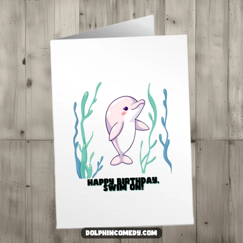 Funny Free Printable Birthday Card showing a dolphin with fins gracefully extended, dancing amidst lush underwater kelp.