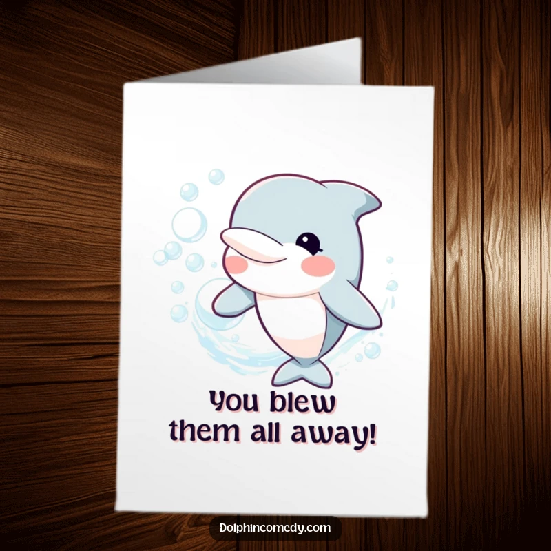Funny free printable congratulations card showing a dolphin joyfully blowing a shimmering ring of bubbles to mark an achievement.