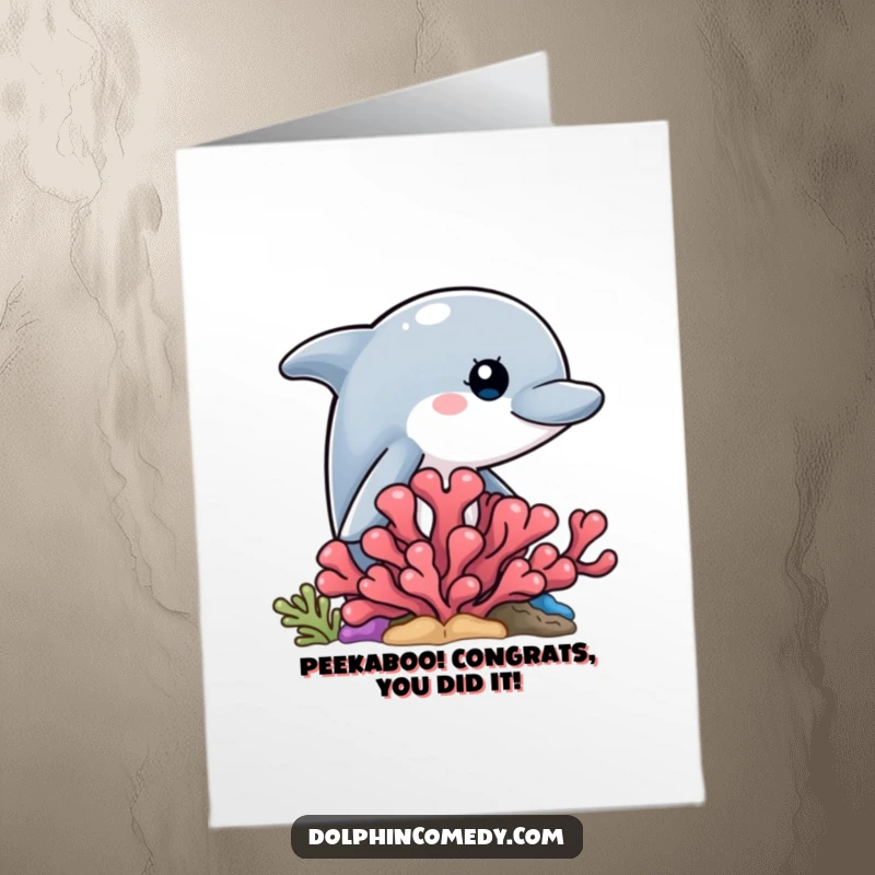 Humorous free printable congratulations card: a curious dolphin peeking from behind coral, offering sneaky celebratory wishes.