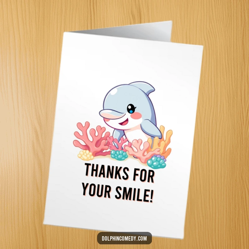 Funny Free Printable Thank You Card: A smiling dolphin peeks from behind a coral reef, offering thanks.